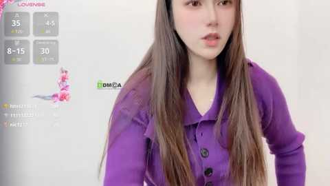 Media: Video of a young Asian woman with long, straight brown hair, wearing a purple cardigan, against a white background. The image includes a virtual reality headset display showing her age, height, and weight.