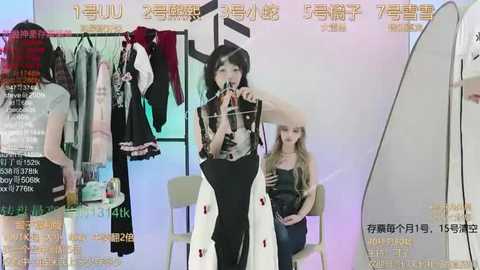 Media: Video of a Chinese woman modeling a black lace dress in a studio, surrounded by clothes and a large mirror. Background features Chinese text and a computer screen displaying product information.