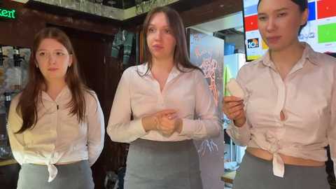 Media: Video of three young women in white button-up shirts tied at the waist, wearing gray skirts. They stand in a bar with colorful advertisements and a green neon sign in the background.