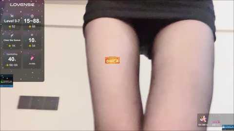 A video shows a person's lower torso in black underwear and a \"Dunkin' Donuts\" logo on their thigh. A digital clock reads \"15:38.\" The background features a white wall and a digital display.