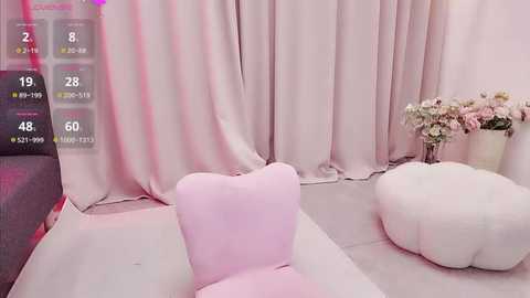 Media: Video of a pastel-colored room with soft pink and white curtains, a white and pink floral arrangement, a fluffy white chair, and a pink ottoman.