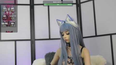 Video of a light-skinned woman with long, blue hair and cat ears, wearing a black, leopard-print dress, in a dimly-lit room with a digital display showing her health and skills.