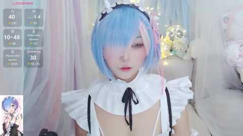 Media: A young woman with light blue bob haircut, wearing a maid outfit with a frilly white collar, sits in a soft, pastel-colored room. Live stream overlay shows chat messages.