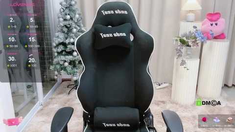 Media: Video of a black gaming chair with \"Twice ohne\" text, in a cozy room with a decorated Christmas tree, plush toys, and a digital overlay showing \"DMGA\" and \"Twitch.\