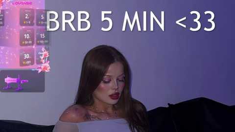 Media: Video of a young woman with long brown hair, wearing dark lipstick, looking down. A purple screen displays BBR 5 min 33.