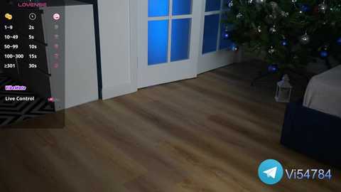 Media: Video of a cozy living room with wooden floor, white double doors, Christmas tree, and blue lights; Livestream Control panel on left.