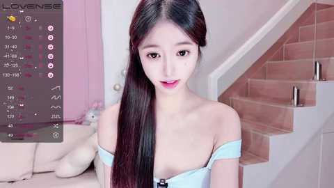 Media: A video of an East Asian woman with long black hair, fair skin, and small breasts, wearing a light blue off-shoulder top, sitting on a staircase with a plush toy beside her.