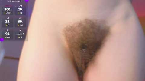 Media: Video of a close-up view of a nude female's pubic region with light brown, curly pubic hair, taken indoors with a smartphone, displaying a digital thermometer reading 30.0 degrees Celsius.