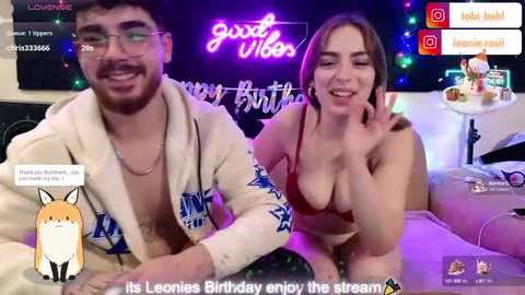 Media: Video of a young, attractive couple in a cozy, dimly lit bedroom, celebrating a birthday on Twitch with playful, flirty expressions.