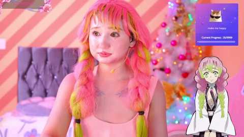 Media: Video of a young woman with pink hair and a black top, smiling in a colorful, festive room with a decorated Christmas tree. Overlay includes a profile of a green-haired woman in a lab coat.