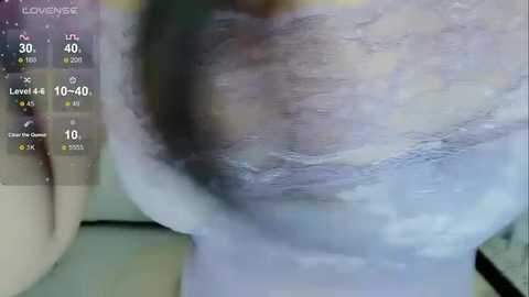 Media: A video of a close-up of a person's arm and chest, covered in white, powdery substance, possibly snow or flour, with a digital overlay showing temperature and weather data.