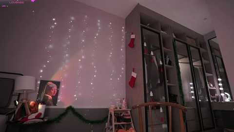 Media: A video of a cozy bedroom with a Christmas tree, twinkling lights, red stockings, and a TV showing a young girl.