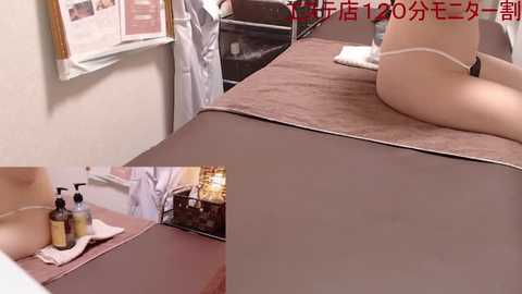 Media: A video of a nude woman lying face-down on a massage table, her pale skin and slender physique visible, with a bottle of oil on a nearby tray. The room has a clinical, beige-toned ambiance.