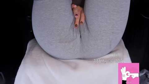 Media: Video of a woman's hand reaching between her large, round buttocks, wearing gray leggings. Dark background. Text in lower right corner reads \"r/18MyFav2017\".