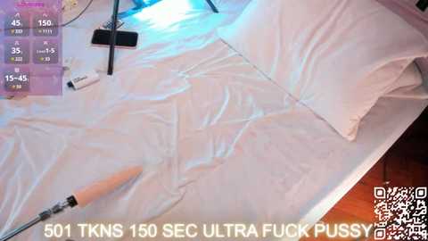 Media: A video of a white bed covered in plastic wrap, a smartphone, a white pen, and a digital timer display, with text reading \"501 TKNS 150 SEC ULTRA FUCK PUSSY.\