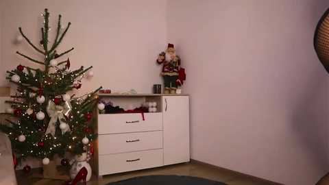 Media: Video of a cozy corner with a decorated Christmas tree, white dresser, and a child's toy soldier figurine on a white wall.