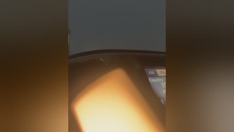 Media: Video of a dark, blurry scene with a soft, warm light casting shadows on a car's dashboard. The time is 6:26 AM, and the \"Calendar\" tab is selected on a digital display.