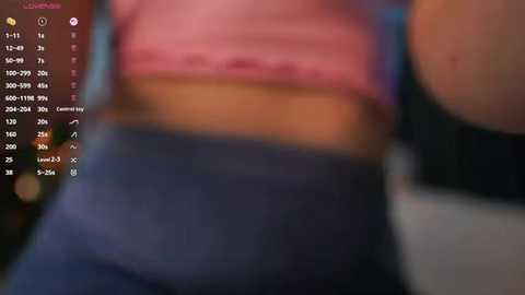 Media: A blurry video of a person wearing a pink top and blue jeans, with a digital interface displaying text and icons in the background.