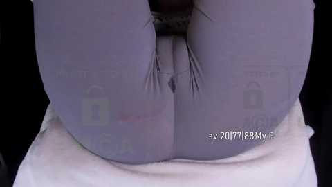 Media: Video of a close-up of a person's buttocks in tight, purple leggings, with visible seams and a faint watermark.