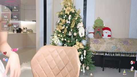 Media: Video of a modern kitchen with a beige quilted chair, a decorated Christmas tree, and a festive table with a snowman and holiday decorations, with digital elements showing a temperature display and a heart emoji.