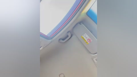 Media: A video captures a close-up of a smartphone's back cover, showing a blue and red design, a yellow label, and a grey handle. The image is slightly blurred.