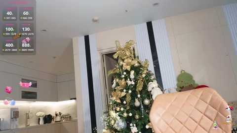 Media: Video of a modern living room with a decorated Christmas tree, beige upholstered chair, and white and black striped curtains. Digital overlay shows game progress with 400 points.