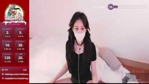 Media: A video of an Asian woman with long black hair, wearing a black top and white mask, sitting on a bed, surrounded by a red, purple, and white interface displaying social media metrics.