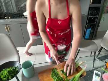 Media: Video of a woman in a red apron cutting green beans on a wooden cutting board in a modern kitchen.