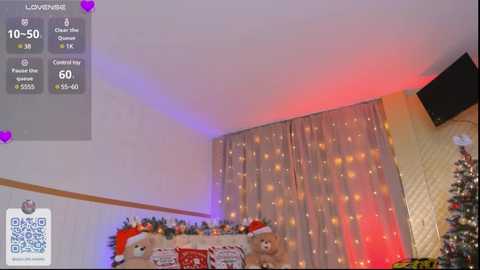 Media: Video of a cozy, festive living room with a Christmas tree adorned with ornaments, a plush teddy bear, and twinkling fairy lights.