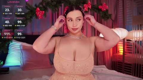 Media: A video of a plus-size woman with large breasts, wearing a sparkly, nude-colored dress, adjusting her hair in a dimly lit bedroom adorned with Christmas decorations and a digital display showing her weight and height.