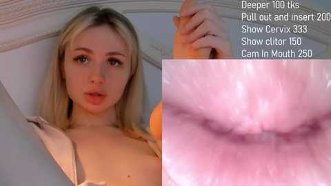 Video of a blonde woman with light skin, wearing a bra, holding a large, realistic sex toy, with a close-up of an erect penis in a vaginal opening.