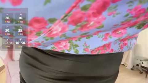 Media: Video of a person wearing a blue floral blouse and black pants, taken from a first-person perspective, with a virtual reality headset overlay displaying health data.