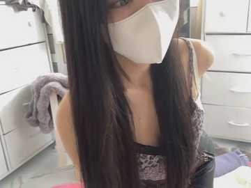 Media: A video of a woman with long, straight black hair, wearing a white face mask, leopard-print top, and glasses, in a bright, modern bathroom with white drawers and a towel.