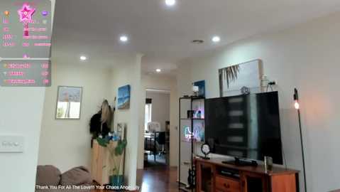 Media: Video of a modern, well-lit living room with a TV, bookshelf, plants, and a framed artwork on the beige walls; a thank-you message is visible.