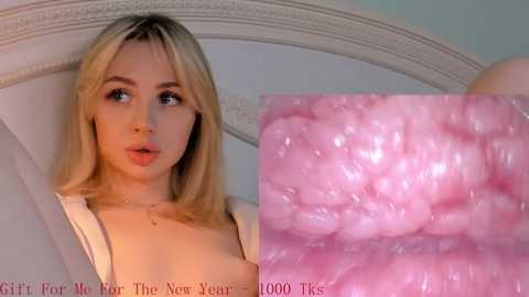 Media: Video of a young Caucasian woman with straight blonde hair, fair skin, and light makeup, looking surprised. Close-up of pink, bumpy cervical cells on the right.