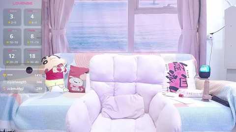 Media: A bright, pastel-toned living room with a plush, white armchair, a colorful pillow, and a window overlooking a serene sea.