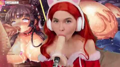 Media: Video of a young Asian woman with long red hair, wearing a white cat ear headband, red Santa hat, and white headphones, performing oral sex on a penis. Background features a cartoon character.