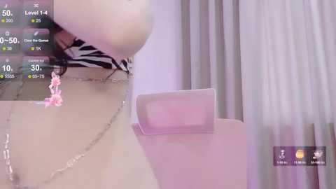 Media: A video showing a virtual reality headset displaying a pink, fluffy object in a room with a white curtain and zebra-patterned chair.