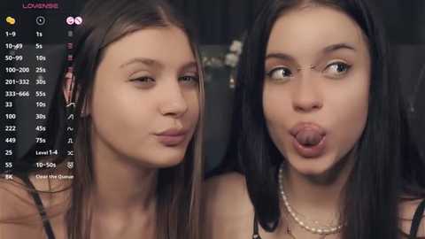 Media: Video of two young women, one with long brown hair, the other with long black hair and glasses, both making playful faces.