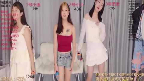 Media: Video of three East Asian women, each wearing different outfits, standing against a gray backdrop with text.