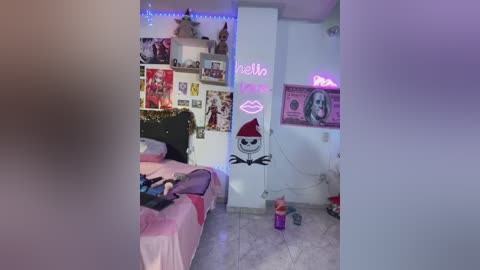 Media: Video of a bedroom with a bed, posters, a neon \"bellas\" sign, and a skull decoration, lit by blue LED strip lights.