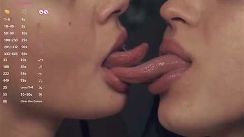 Media: Video of two women kissing passionately, tongues intertwined, in a dark room. Text in the top left corner shows numerical data.