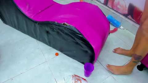 Media: Video of a pink and black inflatable pool float with a purple dildo inserted, on a tiled floor with scattered toys and a can of whipped cream nearby.