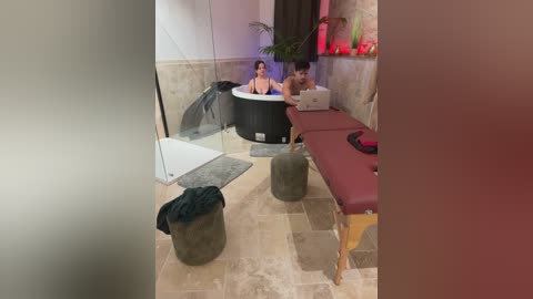 Media: A video of a woman in a bathtub, a man on a massage table, and a nude woman in a corner, in a spa setting.