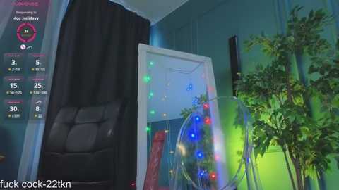 Media: Video of a dimly lit room with a black curtain, a black recliner, a potted plant, and a large glass dome filled with colorful lights.