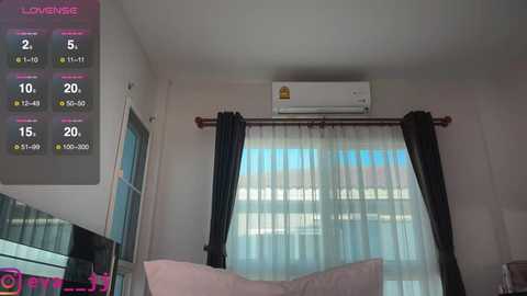 Media: Video of a minimalist, modern bedroom with a large window, sheer white curtains, and dark drapes. A white air conditioner is mounted above the window. The left side features a digital display showing room temperature, humidity, and fan speed.