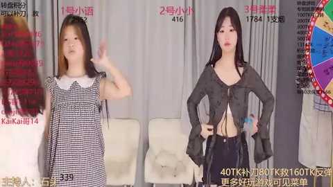 Media: Video of two young Asian women in different outfits, one in a black and white checkered dress, the other in a black lace top and black pants. Background features promotional banners and a colorful wheel graphic.