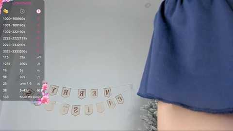 Media: A video of a person in a blue dress with a pink floral headband, standing in front of a wall with a calendar and a \"Congratulations\" banner.