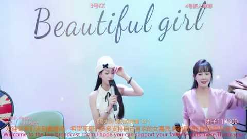 Media: Video of two women on a talk show, one wearing a white hat, the other in a pink jacket, with text overlay in Chinese and English.