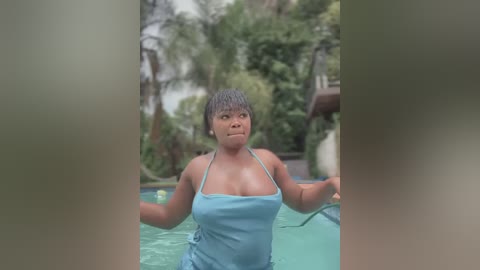 Video of a curvy Black woman with short hair, wearing a light blue bikini top, standing by a pool in a lush, tropical garden.